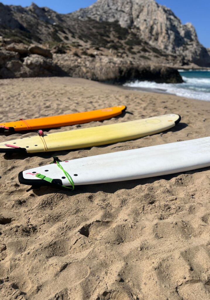 Surfboards lying on the beach at sunny flare light evening in summer, colorful Surfboard on the sand.